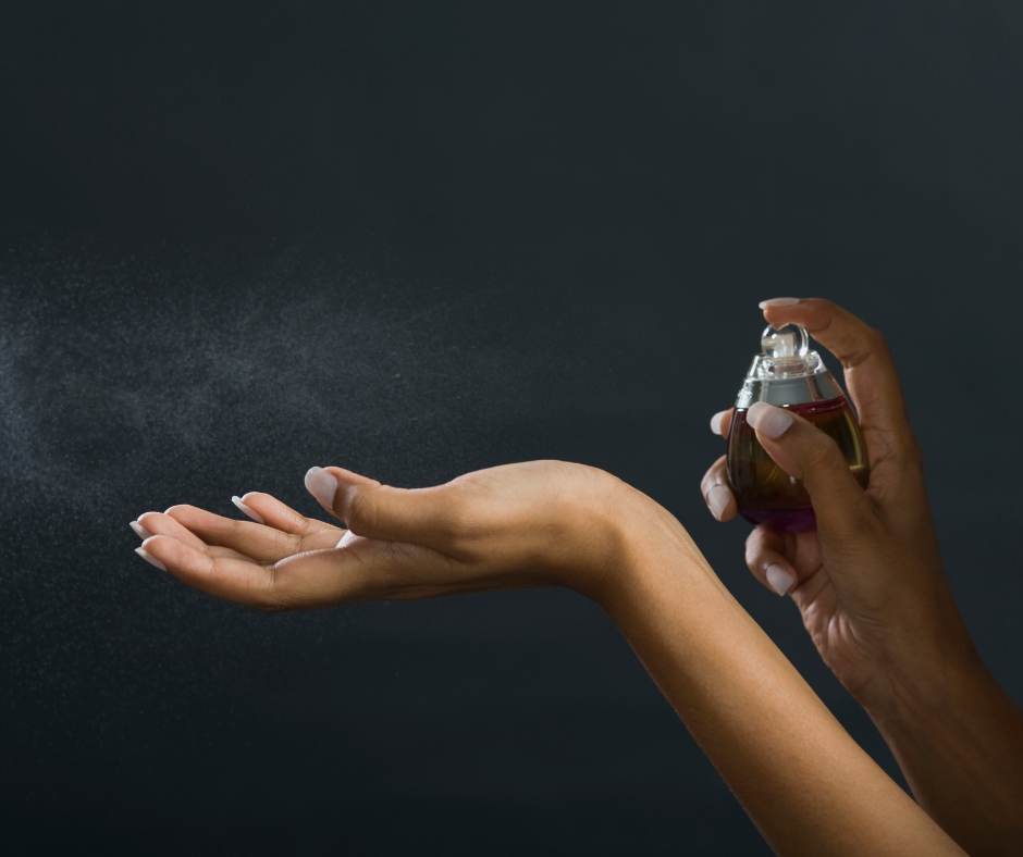 spraying perfume onto wrist