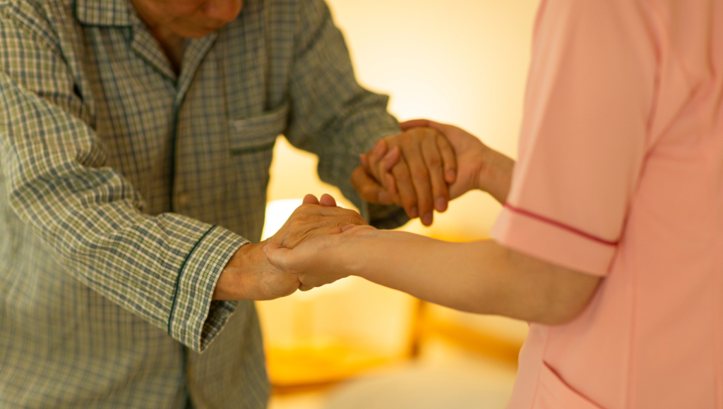carer helping elderly person